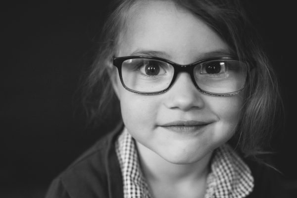cute girl with glasses in a school portrait