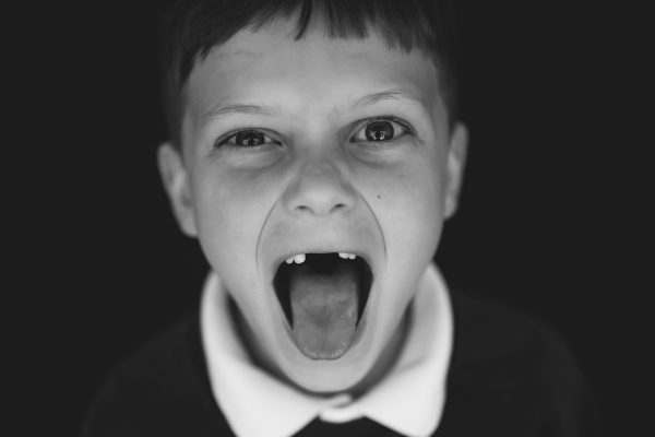 boy with tongue out with no teeth